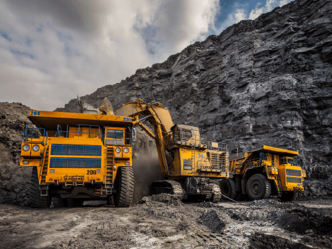 Mining site with heavy equipment, highlighting industrial connectivity and resilient network services for extreme deployment.